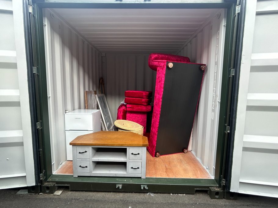 the interior of a 10 foot shipping container showing household furniture inside it