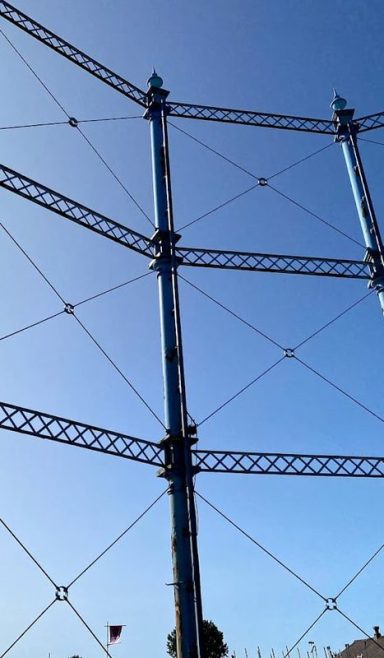 Structure of a gas holder against a clear blue sky at the Rome Street Depot storage facility, Carlisle.