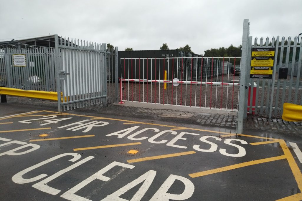 A gated area with a 'Keep Clear' sign and a barrier in an industrial setting.